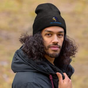Man Wearing a Unisex Style Cuffed Beanie Obi Pompanobi Logo Dark Grey Color