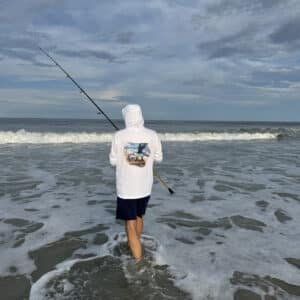 Dorman wearing a Sport-tec Performance Hoodie surf fishing back view