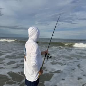 Dorman wearing a Sport-tec Performance Hoodie surf fishing side view